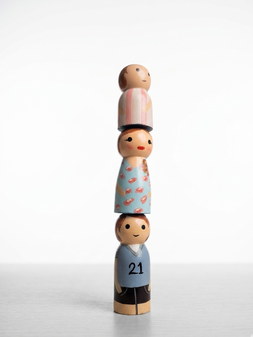Stack of wooden peg dolls on a white background